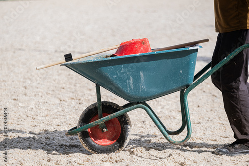 Schilderij op canvas Wheelbarrow and Arena Maintenance Equipment in an Equestrian Arena