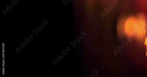 film burn overlay dark cinematic light leak texture with glowing orange flares and dramatic visual atmosphere