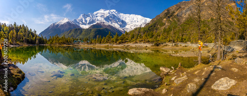 Wide panoramic view of the Annapurna Circuit trek summits in the Himalayas of Nepal, showcasing a vast chain of towering snow-covered peaks, rugged ridgelines, and high-altitude mountain terrain