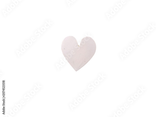 A single soft light pink heart shape on a simple surface isolated on transparent background