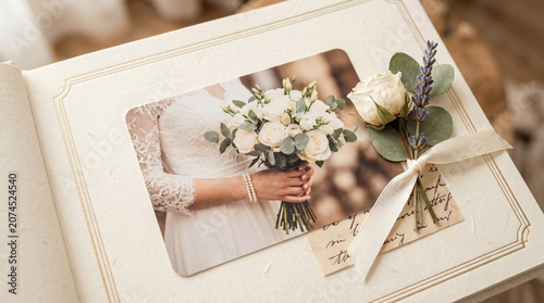 Wedding album with bride’s bouquet photo and decorative elements