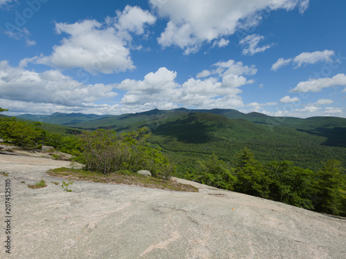 фотографія Granite summit ledge overlooking forested mountain ridges, White Mountains New H
