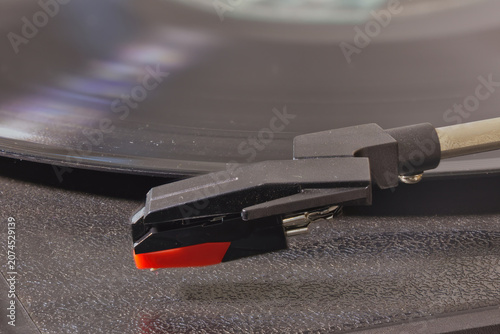 Фотография Close-up of a vinyl record on a turntable.