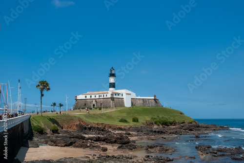 The Barra Lighthouse or Santo Antônio Fort is an iconic tourist attraction in Salvador, Bahia. It offers stunning views of the Atlantic and an unforgettable sunset.