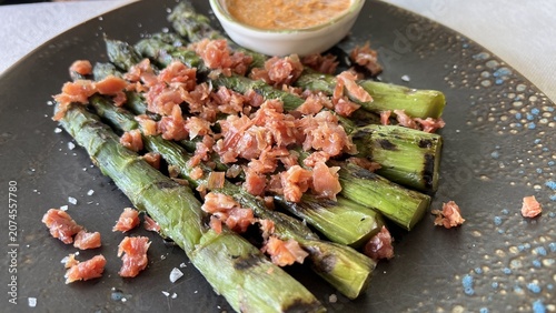 Gourmet green asparagus salad with foie gras close up