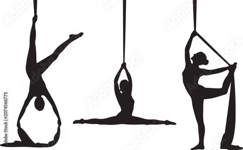 Aerial yoga poses with silk straps