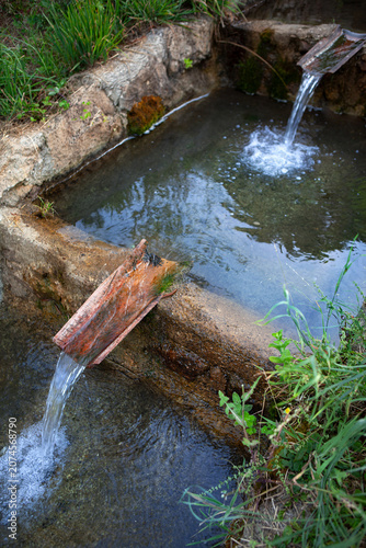 Rustic waterway conduit made of stone and tile
