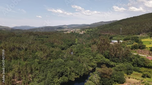 Rio lerez river flowing through abundant forest and mountains with a rural road nearby