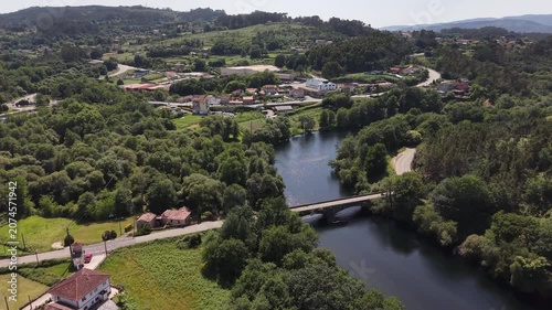 Rio lerez river flowing through abundant forest and mountains with a rural road nearby