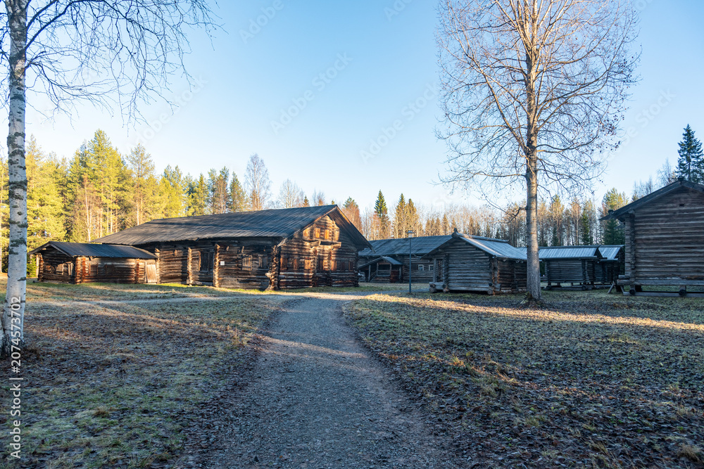 Fototapeta premium Traditional russian log house in rural village landscape