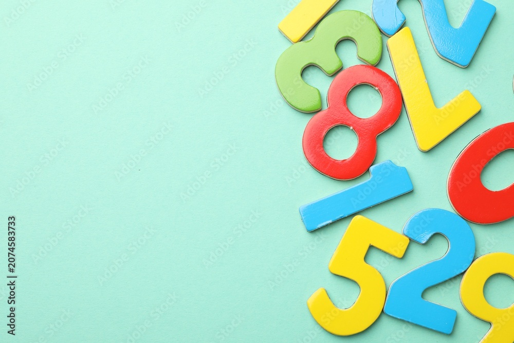 Fototapeta premium Many colorful numbers on turquoise background, flat lay. Space for text