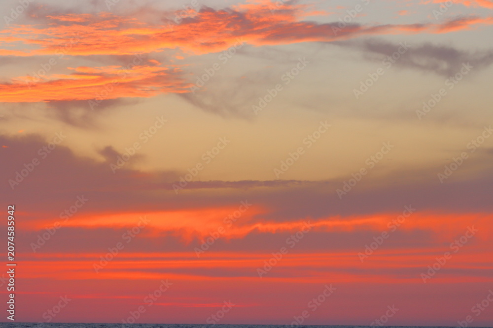 Fototapeta premium Cloudscape, Colored Clouds at Sunset near the Ocean on the Beach