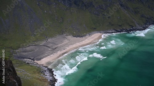 Aerial Drone View of Turquoise Kvalvika Beach with Breaking Waves and Rocky Cliffs, Lofoten Norway
