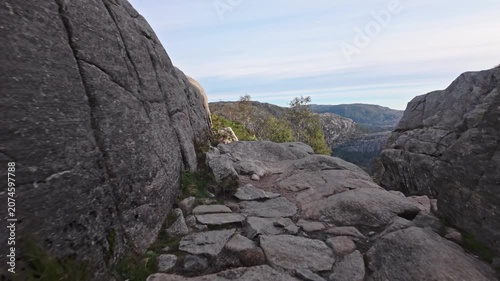 Dramatic Rocky Hiking Trail Through Narrow Granite Boulder Passage on Preikestolen Trek Norway