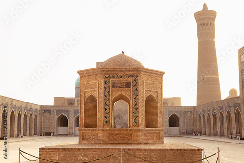 Kalyan Mosque courtyard with octagonal pavilion and Kalyan Minaret in Bukhara, Uzbekistan. Historic Islamic architecture ideal for travel publications and cultural heritage projects.
