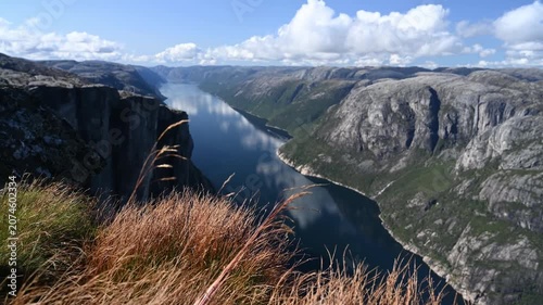 Kjeragbolten Viewpoint Over Lysefjord Fjord with Swaying Autumn Grass and Rocky Cliffs Norway