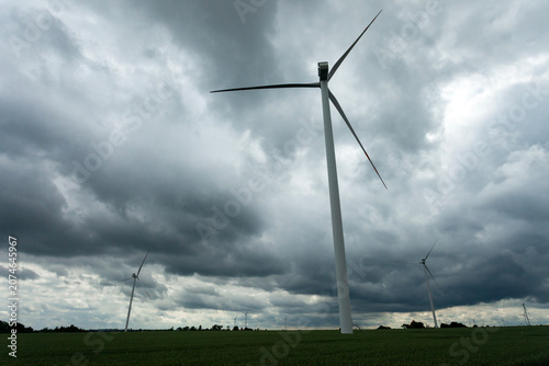 Wind turbines against a cloudy sky