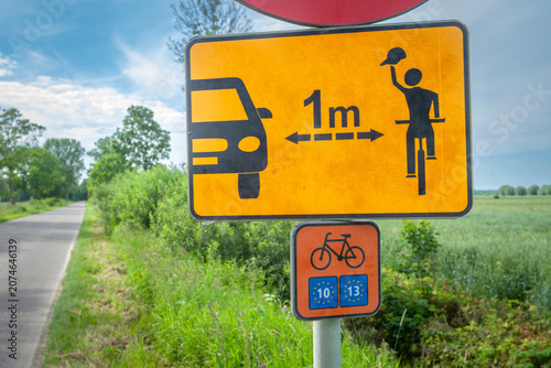 A road sign on the eurovelo cycle path informing about keeping a safe distance from cyclists