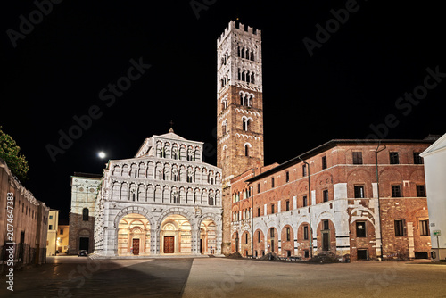 Lucca, Tuscany, Italy: night view of the medieval Roman Catholic Cathedral of St Martin of Tours, a masterpiece of art and architecture, in the historic center of the ancient Tuscan city