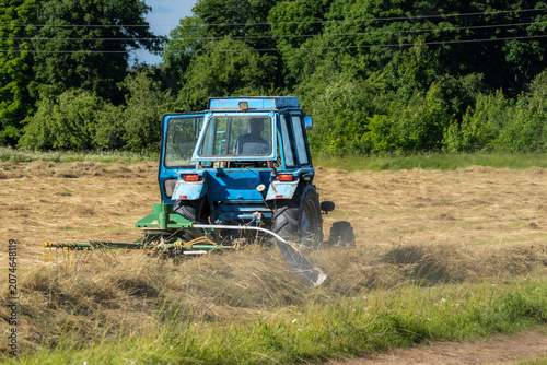Photos Old Tractor Raking Hay in Rural Field During Summer Harvest, Livestock Feed and