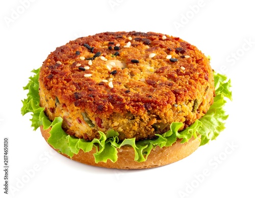 Crispy vegetarian veggie burger patty on fresh lettuce and bun with vegetarian