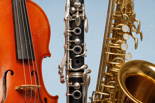 Violin clarinet and saxophone lined up together representing musical instruments and music education