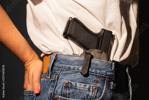 Canvas Print Close up view of a modern semi automatic handgun pistol inside an IWB waistband