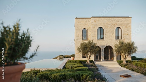 Mediterranean villa features classic stone architecture with a private infinity pool overlooking the calm blue ocean.