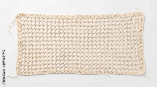 Beige handmade crochet fabric swatch with a square grid pattern isolated on a white background