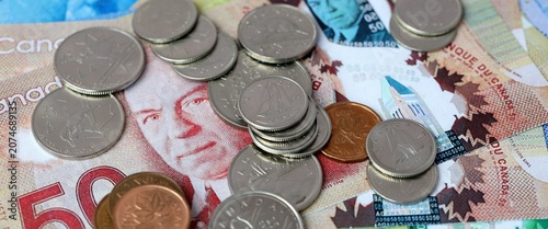 Canadian dollar money bills and coins on table. Canada cash of CAD currency close up