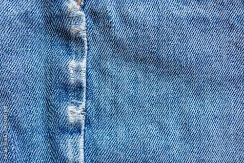 Obraz na plátně Close up of naturally worn denim fabric with abrasion along seam caused by prolo