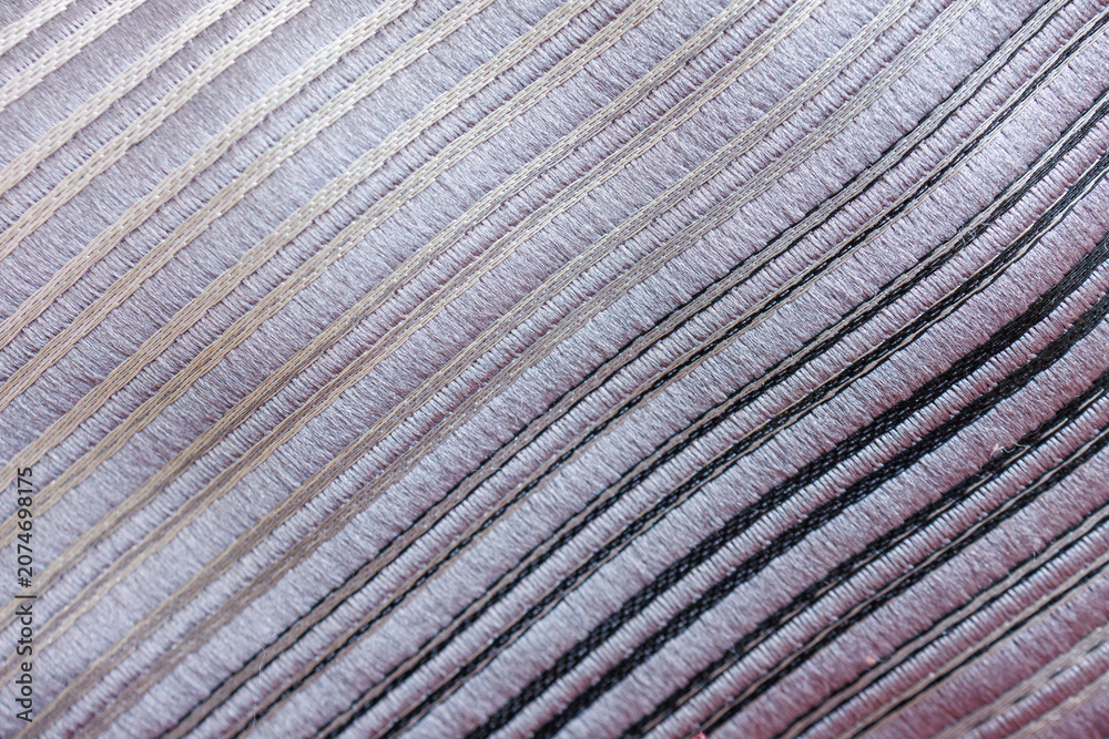 Fototapeta premium Decorative striped upholstery fabric with parallel stitched lines creating elegant textile texture