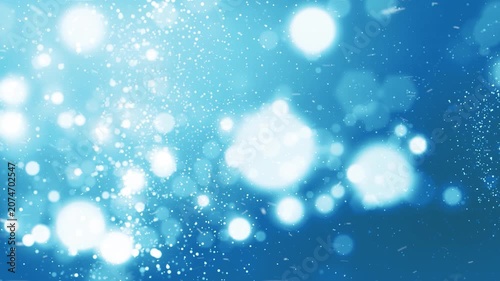 Winter Blue Abstract Snowstorm 4K Loop features blurred spheres and particles flying across the scene to create an abstract winter blizzard in a blue gradient atmosphere in a loop.