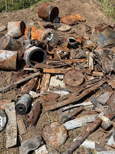 Discarded agricultural equipment and containers on a farm in Kenya