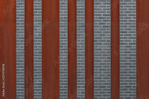 Rusty Corten Steel Panels and Gray Brick Wall Creating a Modern Geometric Facade