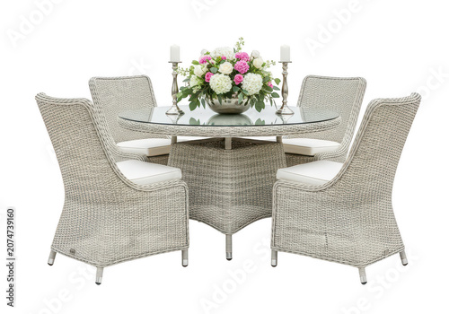 Wicker patio dining set with floral centerpiece.