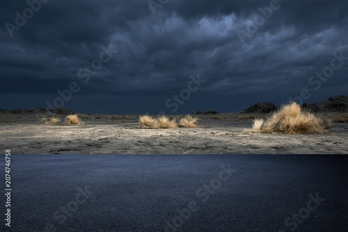 A desolate, arid landscape under a stormy, dark sky
