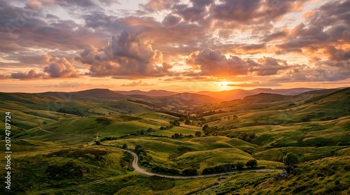 Rolling green hills at sunset, warm amber light, dramatic clouds, no people
