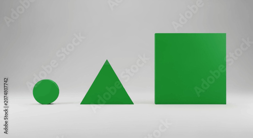 Three simple green geometric shapes arranged on a plain white studio background