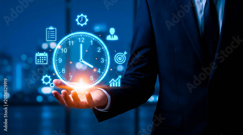 Quadro su tela Businessman Holding Glowing Holographic Clock for Time Management