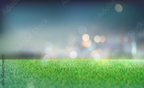 Football stadium background. Empty football stadium with green field and blur spotlights.