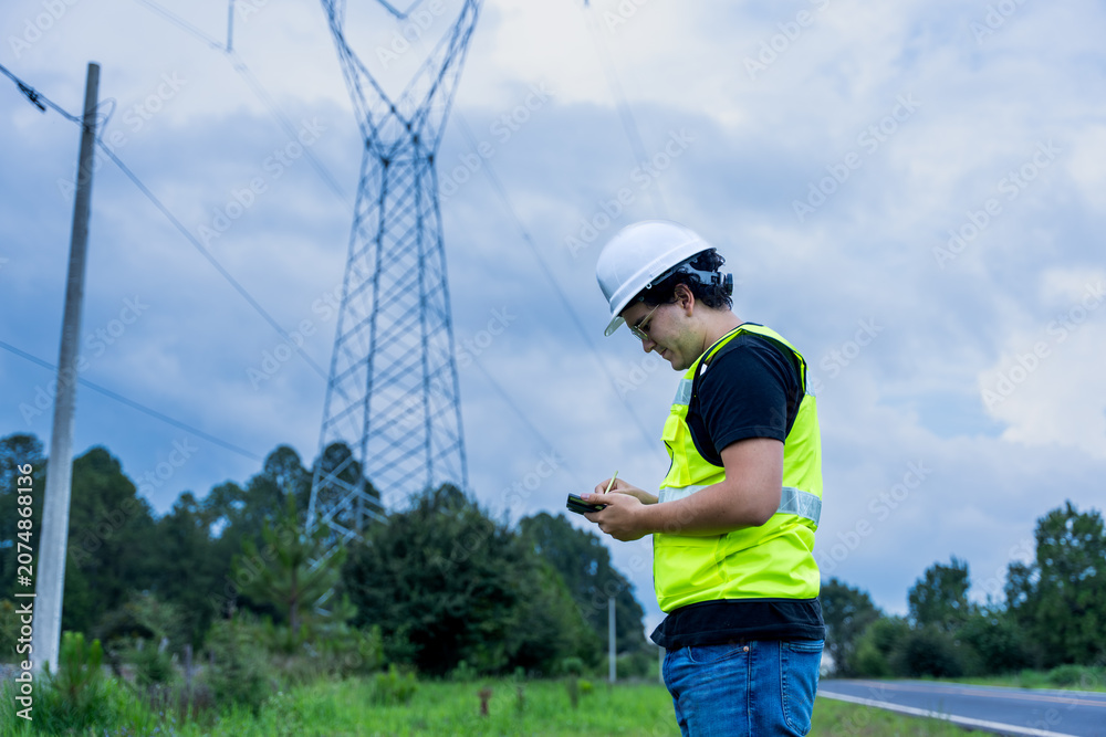 Naklejka premium Engineer checking power grid infrastructure in safety gear