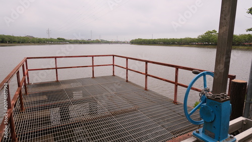 Fotografie Industrial Water Treatment Facility with Control Valve and Metal Platform