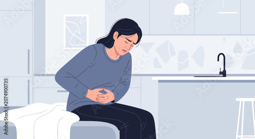 Woman Experiencing Abdominal Discomfort and Pain While Sitting at Home in Kitchen