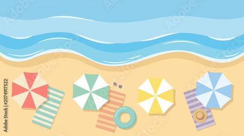 Top view of summer beach with ocean, sand, colorful umbrellas, and towels.