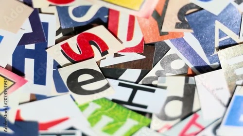 Spinning Background of Mixed Cut-Out Newspaper and Magazine Letters in Different Fonts