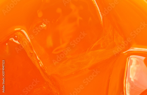Refreshing Orange Juice with Ice Cubes Close-up,Macro,A vibrant macro close-up shot of refreshing orange juice submerged with clear ice cubes, capturing the bright color and texture of a cold summer.