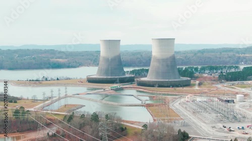 Aerial View of Nuclear Power Plant Cooling Towers Next to a Lake