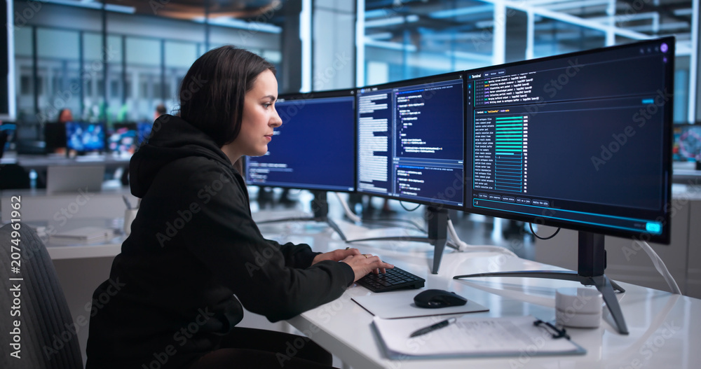 Fototapeta premium Young Female Software Developer Coding Interactively