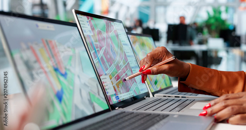 Fotografie Young Woman Uses Laptop For Urban Planning